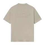 Polera Fear of God Essentials Classic Logo Metálico FW25 - Beige